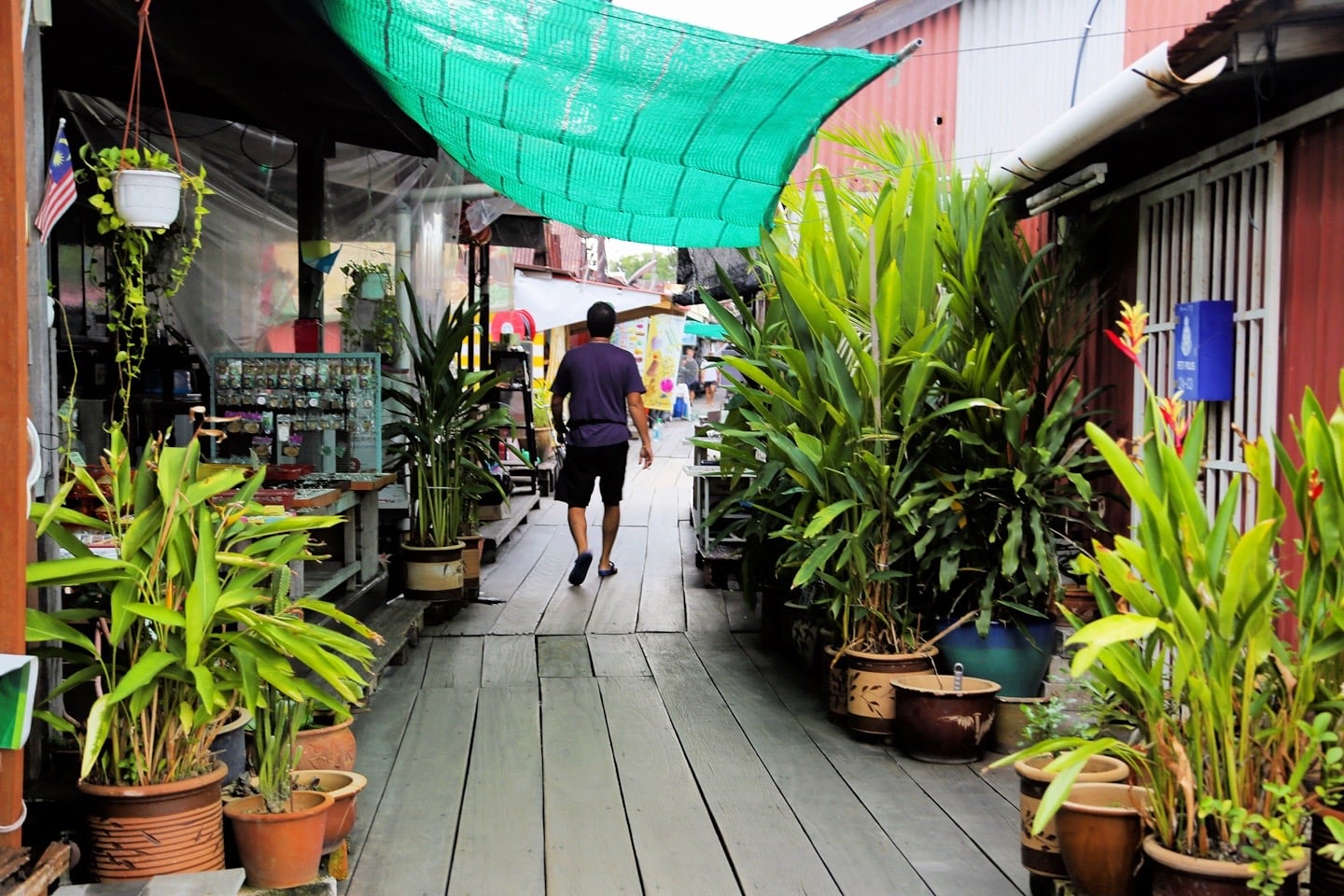 man walking in the clan jetties of Penang