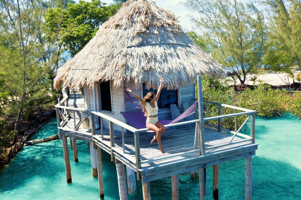 woman on overwater bungalows in the Caribbean in Belize