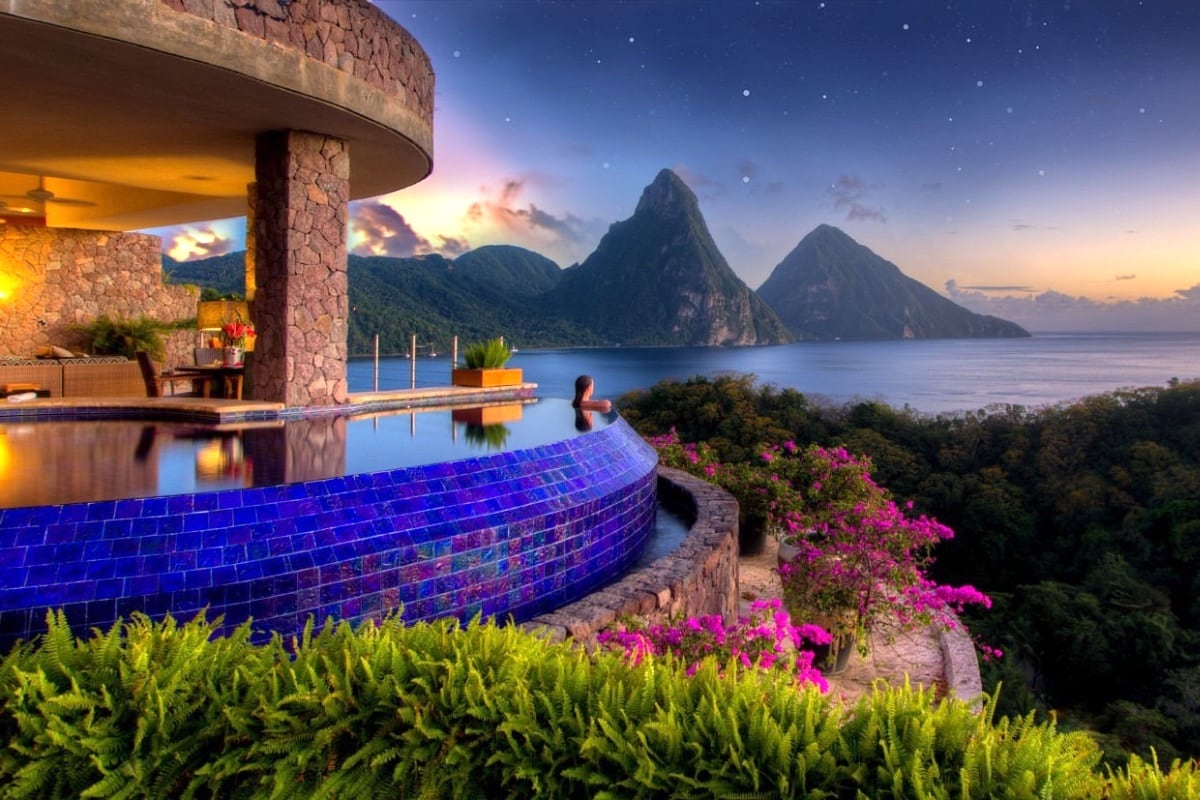 woman in resort pool with sunset mountain view