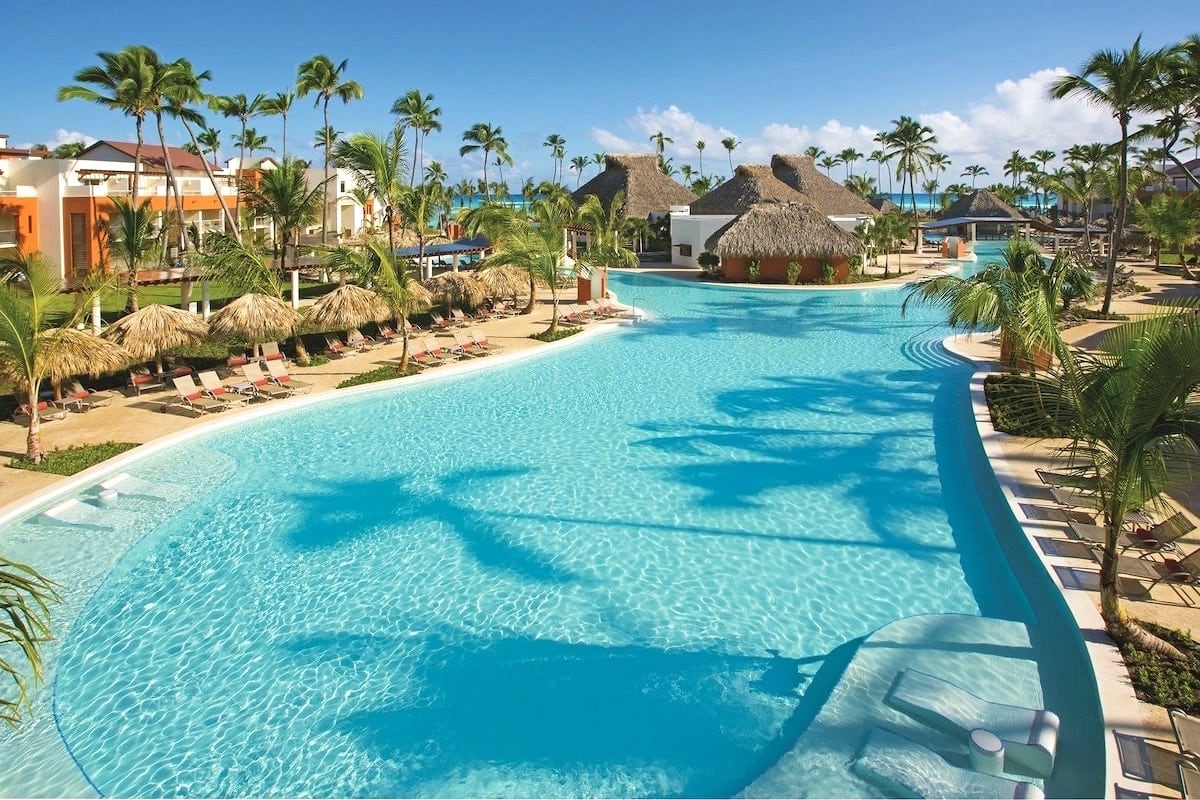 large hotel pool surrounded by palms