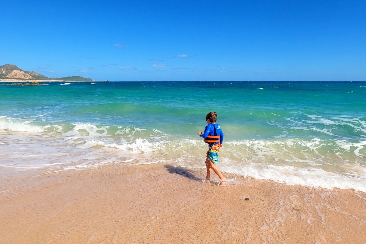 child playing at Los Arbolitos Beach