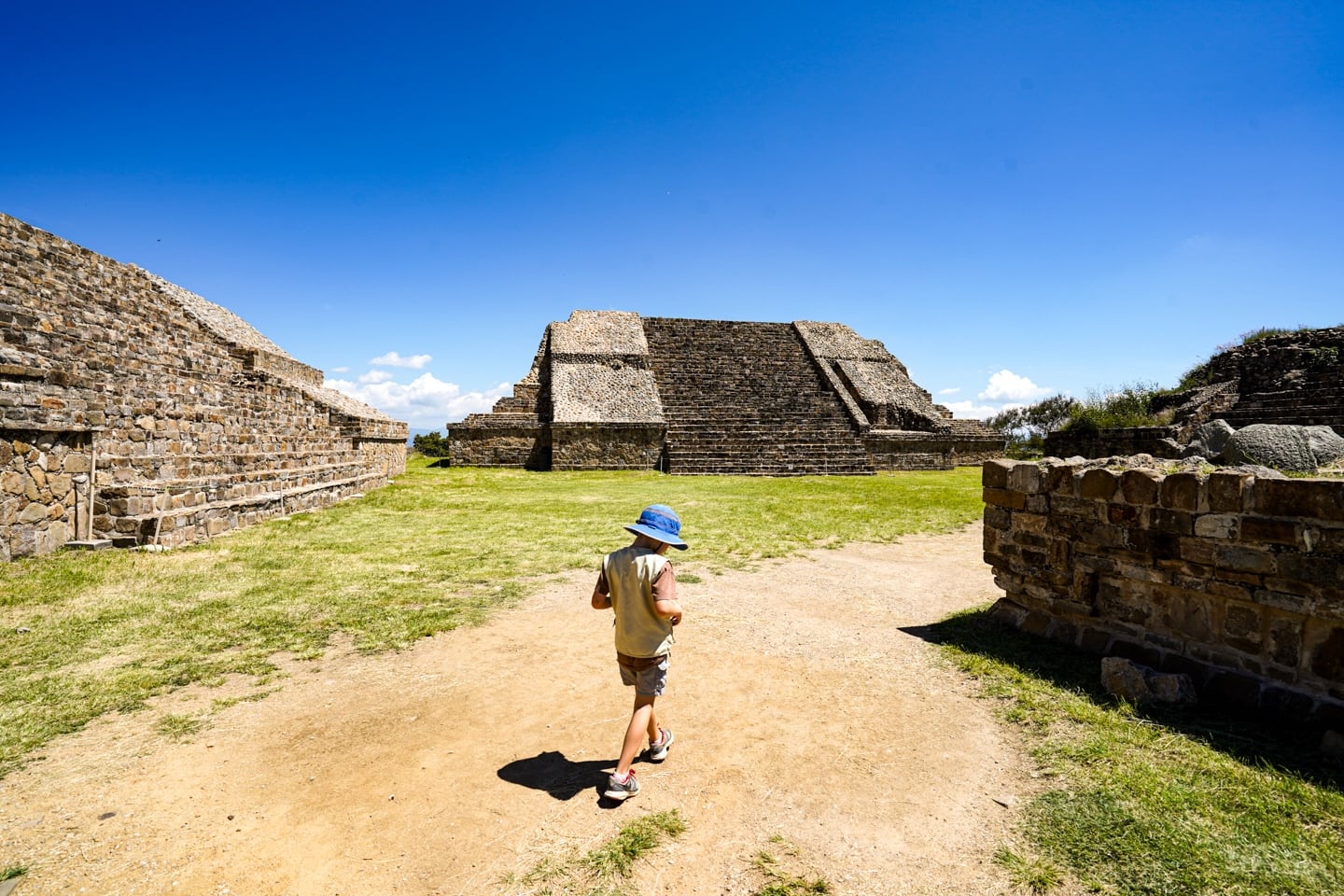 child walking around Monte Alban pyramids in Oaxaca Mexico