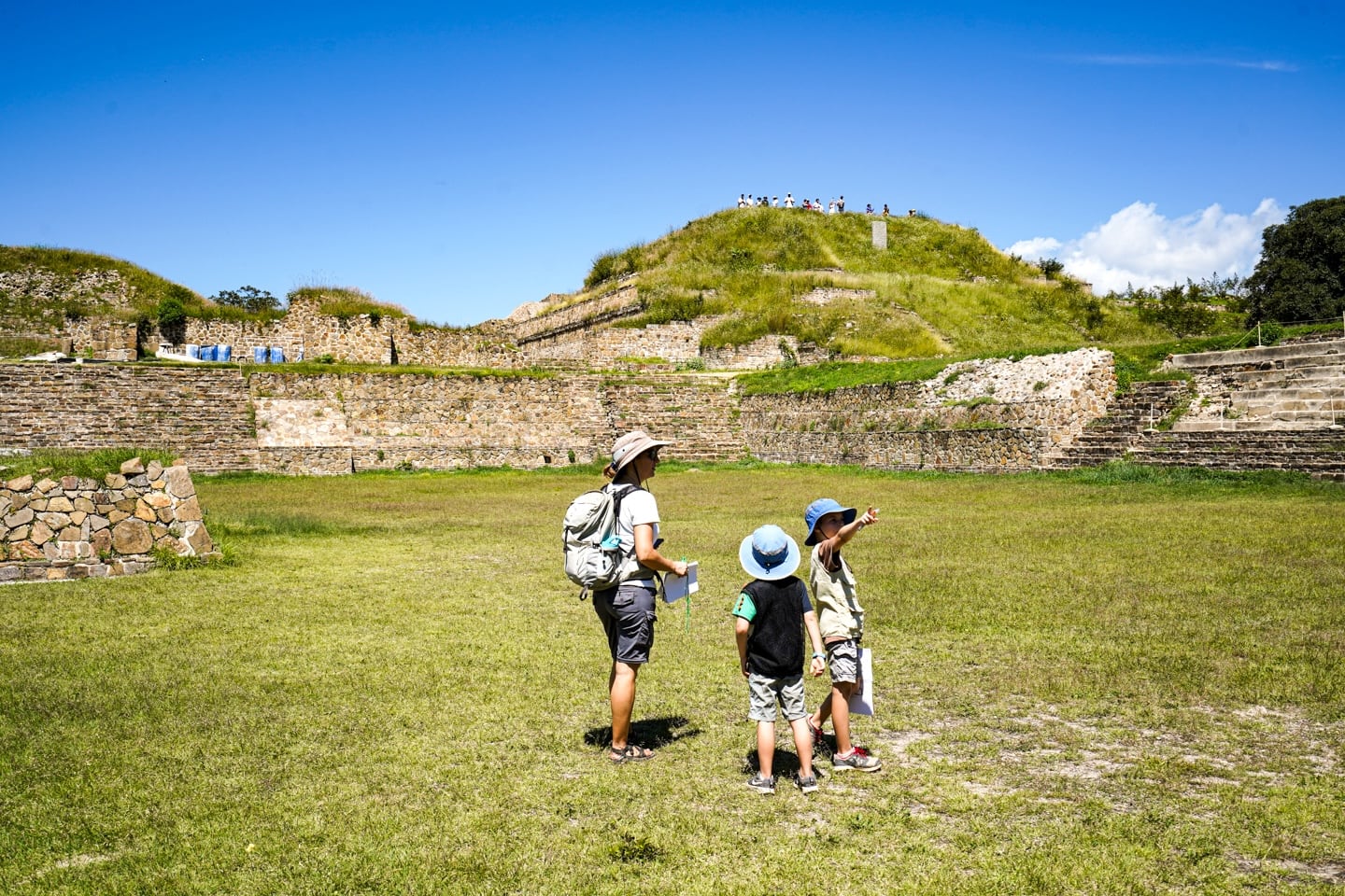 people touring the ancient ruins of Monte Alban in Oaxaca Mexico