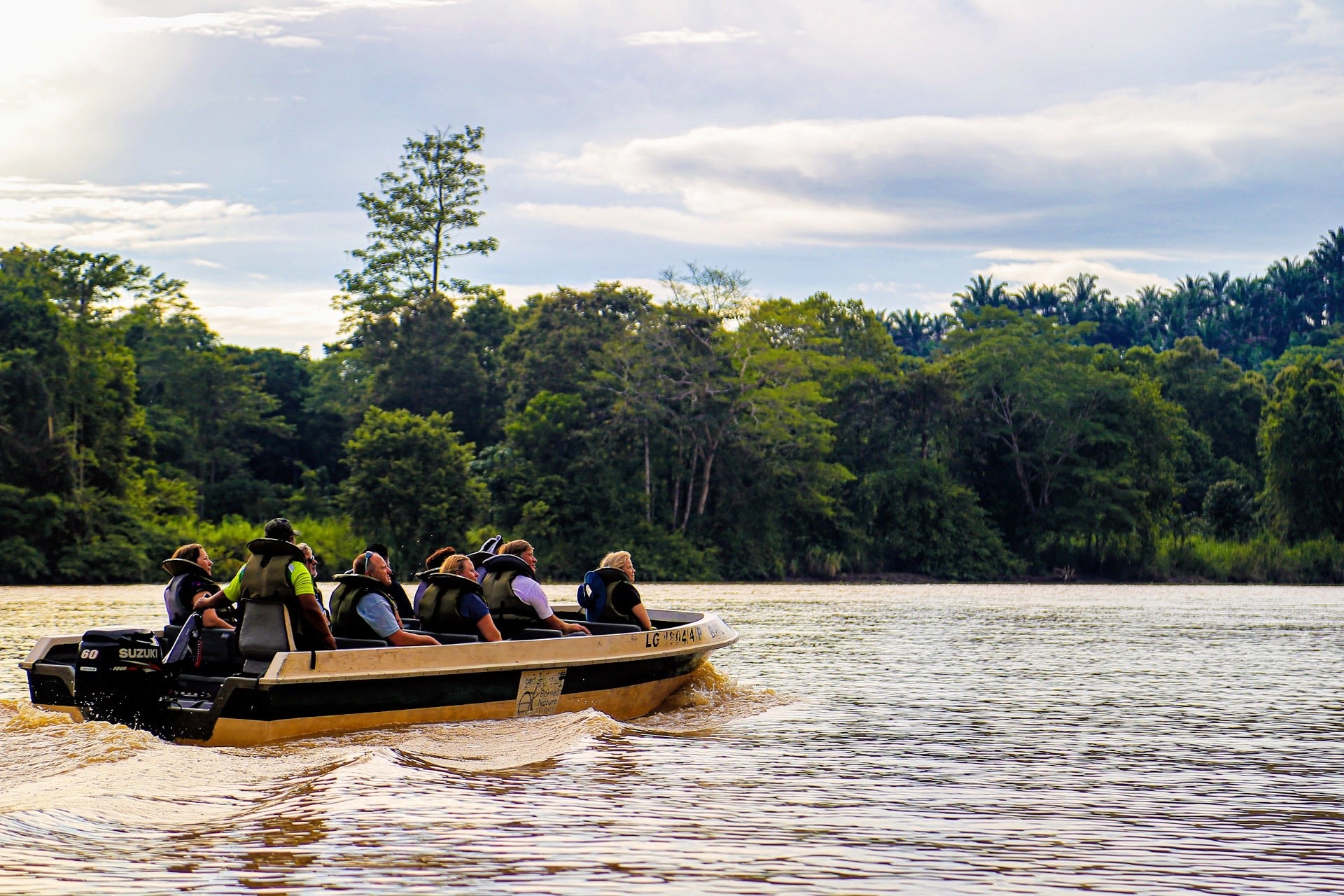 people on boat on a Kinabatangan River cruise tour in Borneo